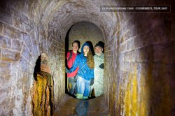 Kyiv underground tour - group of tourists inside the drain systen
